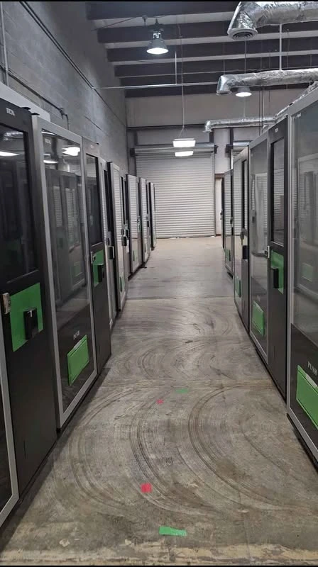 Actual Stratamize machine inventory with rows of full-size cabinets and green pickup doors